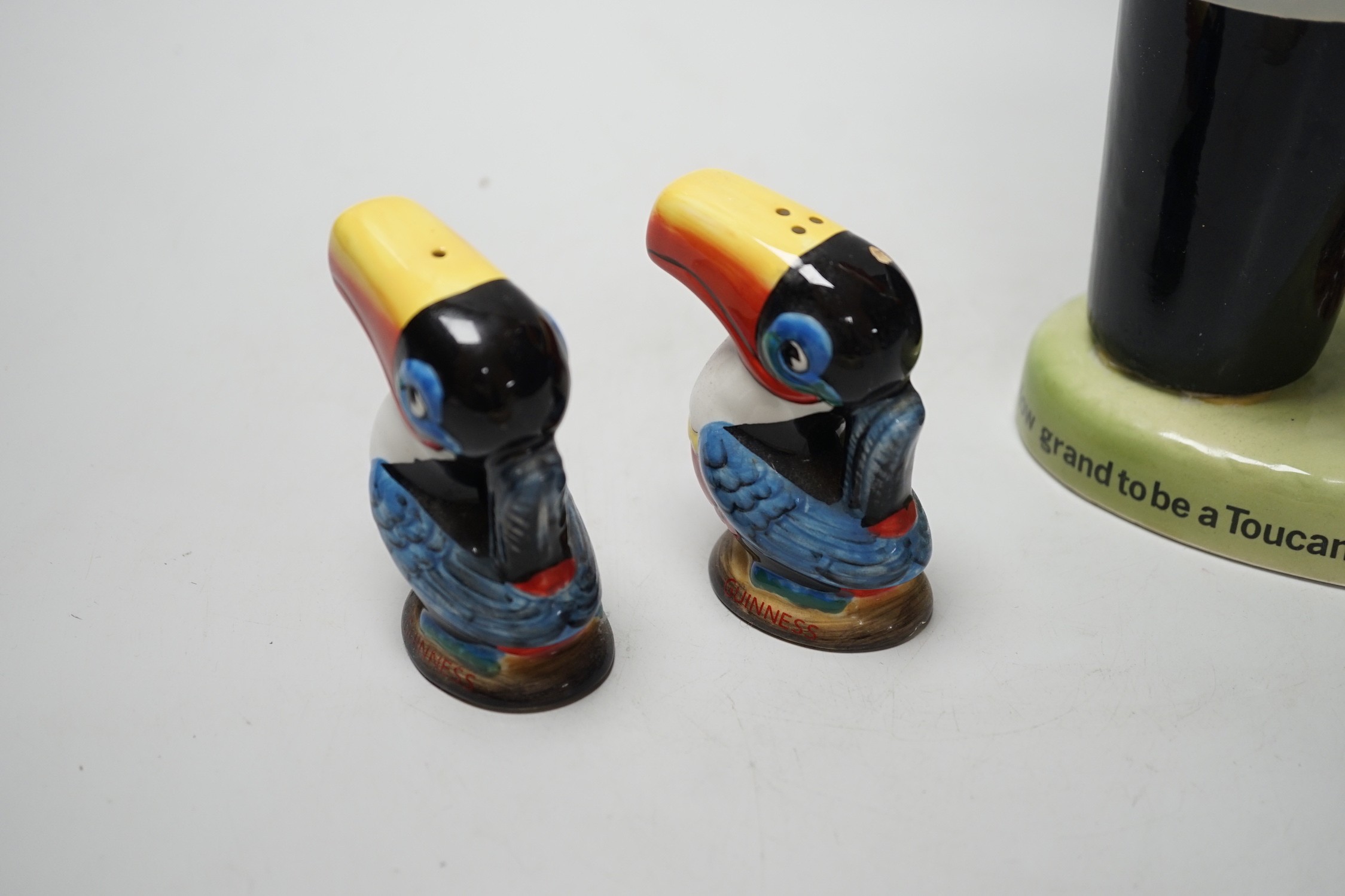 A Guinness toucan lamp-stem, 26cm high, and three related items